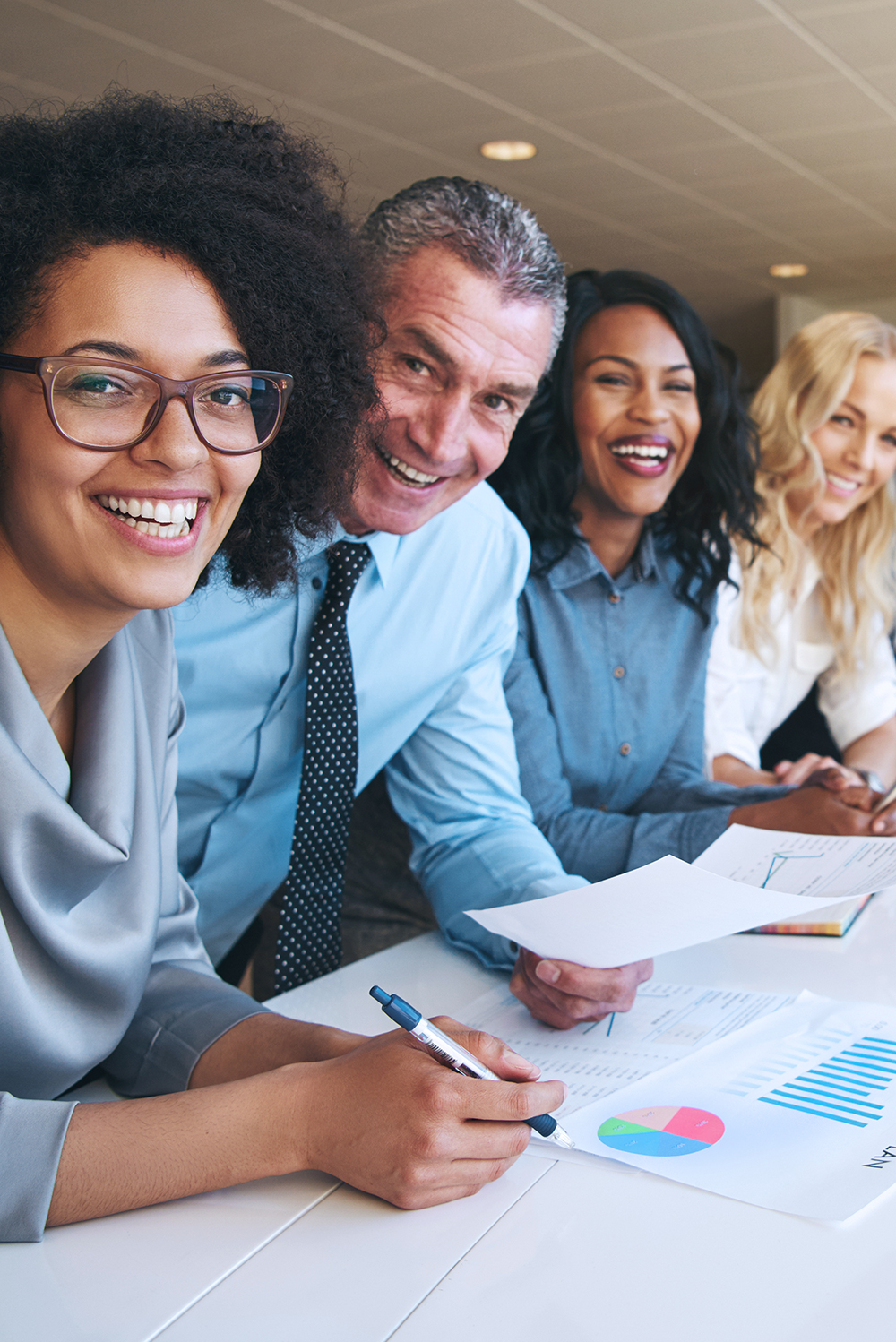 Happy employees smile during a staff meeting