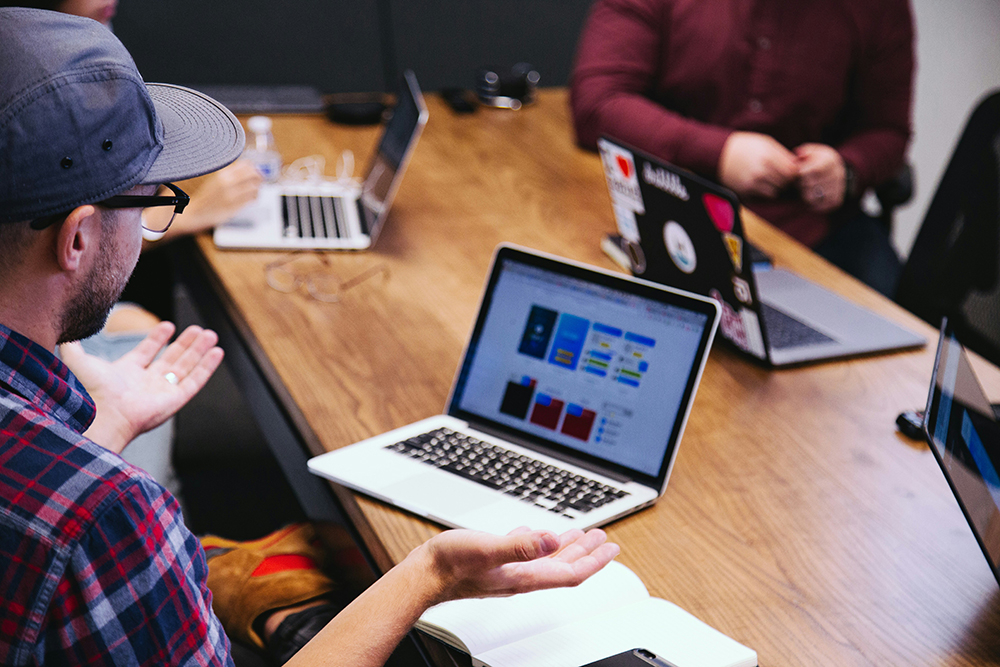 Man offers feedback during staff meeting